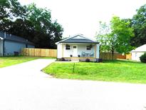 Charming single-story home with a welcoming front porch, freshly cut grass, and a new wooden fence at 109 W Poplar St, Stanley, NC 28164