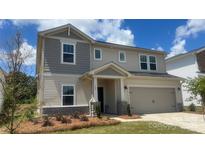 Charming two-story home featuring a two-car garage and landscaped front yard at 121 Vaquaro Dr, Mooresville, NC 28115