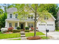 Charming two-story home with a well-manicured front yard, complemented by an attached two-car garage at 12531 Morning Creek Ln, Charlotte, NC 28214