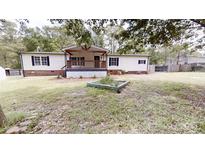 Charming single-story home with a covered front porch and well-maintained lawn at 1274 Oakbrook Ln, Denver, NC 28037