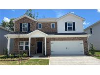 Charming two-story home with brick accents, a two-car garage, and a well-manicured lawn at 138 Shepherds Landing Dr, Mooresville, NC 28115