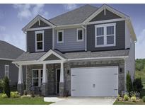 Charming two-story home featuring stone accents, a covered porch, and a spacious two-car garage at 138 Shepherds Landing Dr, Mooresville, NC 28115