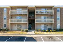 Three-story condo building featuring multiple balconies and updated facade at 1620#F Arlyn Cir, Charlotte, NC 28213