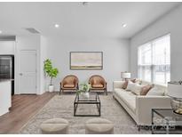 Bright living room featuring hardwood floors, natural light, and contemporary furnishings at 1834 Teachers House Nw Rd, Concord, NC 28027