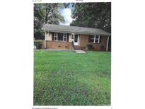 Charming single-story home with brick and siding exterior, and a large front yard at 2831 Denview Ln, Charlotte, NC 28208