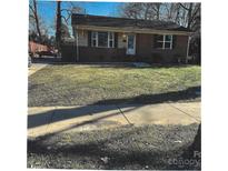 Charming brick home featuring a well-kept lawn and a cozy, inviting exterior at 2831 Denview Ln, Charlotte, NC 28208