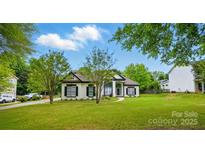 Charming two-story home featuring classic white paint and black trim and shutters at 530 Dovefield Dr, Indian Trail, NC 28079
