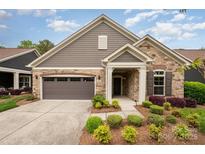 Beautiful home featuring a stone and siding exterior, a two-car garage, and a professionally landscaped front yard at 1008 Avalon Pl, Matthews, NC 28104