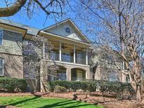 Stunning condo exterior showcasing a covered porch, brick accents, and lush landscaping at 1123 Park West Dr, Charlotte, NC 28209
