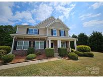 Charming two-story home with a combination of stone and siding, complemented by manicured landscaping at 11922 Kimberfield Rd # 37, Matthews, NC 28105