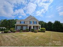 Traditional two-story house featuring a well-manicured lawn and classic architectural design at 11922 Kimberfield Rd # 37, Matthews, NC 28105