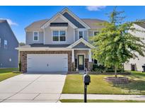 Charming two-story home with a manicured lawn, a two-car garage, and stylish exterior features at 15127 Oleander Dr, Charlotte, NC 28278