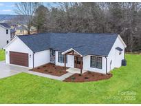 Charming single-story home with white siding, a dark roof, and a well-manicured lawn at 28647 Nc Hwy 73 Hwy, Albemarle, NC 28001