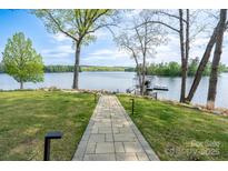 View of lake from backyard through landscaped path leading to private dock at 302 Patterson'S Bridge None, New London, NC 28127