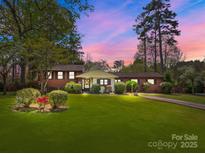 Charming brick home with a well-manicured lawn and beautiful landscaping at 365 Pine Hill Rd, Salisbury, NC 28144