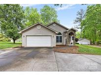 Charming stucco home with a two-car garage, stone accents, and a well-manicured front yard at 3764 Glenn Oaks Dr, Maiden, NC 28650