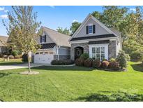 Charming home featuring a stone facade, manicured lawn, and a two-car garage at 4012 Brandywine Ter, Lancaster, SC 29720