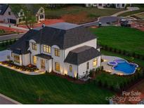 Expansive property showcasing a well-manicured lawn and a luxurious pool area with a spa and patio at 405 Sugar Maple Ln # 41, Weddington, NC 28104