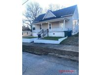 Classic home featuring a covered front porch with tidy landscaping and ample natural light at 421 E Cemetary St, Salisbury, NC 28144