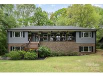 Charming home featuring a welcoming front porch with decorative plants and fans at 4517 Lake Shore N Rd, Denver, NC 28037