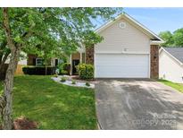 Charming single-Gathering home with a well-manicured lawn, mature trees, and a two-car garage at 5927 Patricia Ryan Dr, Charlotte, NC 28216