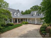 Charming two-story home with three-car garage, a brick driveway, and a landscaped front yard at 7701 Gold Hill Rd, Rockwell, NC 28138