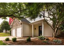 Charming two-story home featuring a stone facade, attached two-car garage, and inviting front porch at 8607 Cedardale Ridge Ct, Charlotte, NC 28269