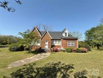 Charming brick home with a well-manicured lawn and colorful landscaping at 8664 Nc 742 S Hwy, Wadesboro, NC 28170
