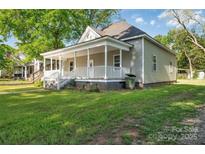 Charming home featuring a cozy front porch with a white railing and a well-manicured lawn at 126 Hemphill Ave, Chester, SC 29706