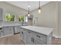 Modern kitchen features an island with a marble countertop and stainless steel appliances at 126 Hemphill Ave, Chester, SC 29706
