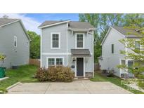 Charming two-story home featuring a gray siding, stylish windows, and a well-manicured front yard at 2821 Shamrock Dr, Charlotte, NC 28205