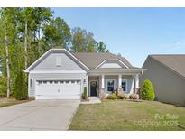 Charming single-story home with a manicured lawn, attached two car garage and welcoming front porch at 4607 Walking Path Dr, Waxhaw, NC 28173