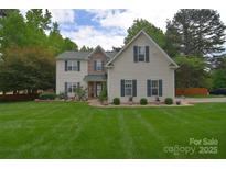 Charming two-story home with green shutters, manicured lawn, and beautiful landscaping at 9106 Dogwood Ridge Dr, Charlotte, NC 28227