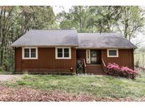 Charming, single-story house with a brown exterior, gray roof, and landscaped front yard at 948 Kingswood Dr, Rock Hill, SC 29732