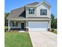 Charming two-story home with a well-maintained lawn, stone accents, and a two-car garage at 2226 Catawba Trace Dr # 11, Catawba, NC 28609