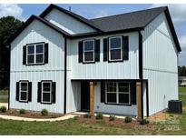 Charming two-story home featuring white siding, black trim, and a welcoming front porch at 3012 Isle Ln, Monroe, NC 28110