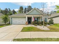 Charming single-story home features a two-car garage and inviting front porch at 476 Dudley Dr, Fort Mill, SC 29715