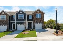 Charming townhomes with individual garages, stone accents, and well-manicured lawns create inviting curb appeal at 6153 Helens Rest Ln, Lincolnton, NC 28092