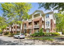 Beautiful multi-story brick condo building with manicured landscaping and a charming facade at 921 Northeast Dr # 39, Davidson, NC 28036