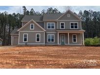 Charming two-story home featuring a classic facade, large windows, and a well-manicured front yard, blending comfort and style at 117 Blackbeard Ln, Mooresville, NC 28117