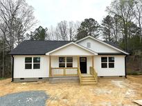 Charming single-story home boasting a classic design, natural wood accents, and a welcoming covered porch at 1212 Belmont Circle Dr, Lancaster, SC 29720