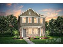 Charming two-story home with stone accents, manicured lawn, and inviting landscaping at 14032 Penbury Ln # 332, Charlotte, NC 28273