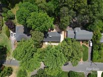 Aerial view of property showcasing lush greenery, well-maintained roofs, and ample parking at 2601 Pinewood Rd, Gastonia, NC 28054