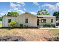 Charming renovated ranch-style home featuring new siding and well-maintained landscaping at 504 N Hawthorne St, Mount Holly, NC 28120