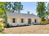 Charming, renovated single-story home with painted brick, manicured landscaping, and a welcoming front entrance at 5514 Milford Rd, Charlotte, NC 28210