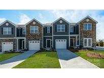 Charming townhome with stone accents, attached garage and manicured lawn at 6157 Helens Rest Ln, Lincolnton, NC 28092