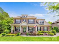 Beautiful brick two-story home with an inviting front porch and manicured landscaping at 8169 Clems Branch Rd, Indian Land, SC 29707