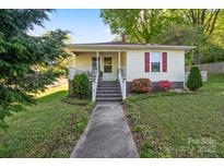 Charming home featuring a cozy front porch, landscaped yard, and classic design at 912 W A St, Kannapolis, NC 28081