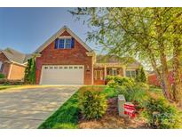Charming brick home featuring an attached two-car garage and mature landscaping at 138 Victoria Park Dr # 170, Shelby, NC 28150