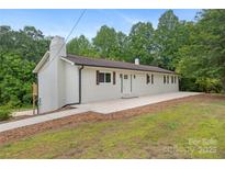Charming brick ranch features lovely landscaping, a brick chimney, and a freshly painted exterior at 1904 27Th Avenue Ne Dr, Hickory, NC 28601